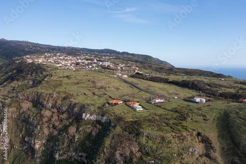 Great drone photo of a small village in Madeira built on huge cliffs.