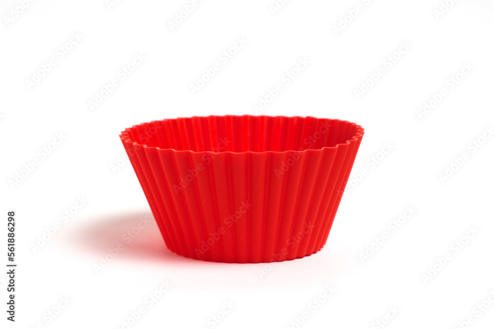Red silicone mold for baking cupcakes on a white background Red silicone mold for baking cupcakes on a white background