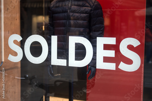 Closeup of discount sign SOLDES in french,  the traduction of  sales in english on the window of fashion store photo
