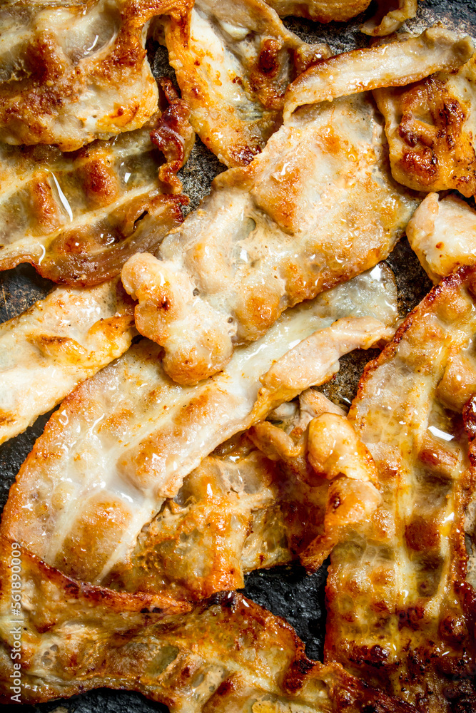 Fried bacon in a frying pan.