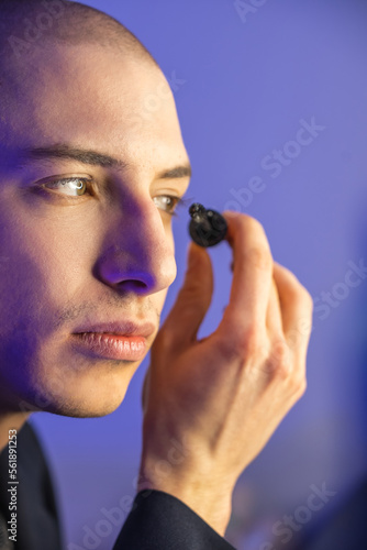 Close up face of a young homosexual man applying mascara. High quality photo