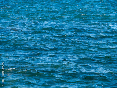 Beautiful water surface as a background. The texture of water. Blue body of water