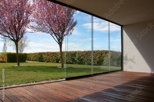 Foto Enclosed patio with wooden deck, glass sunroom with deck enclosure overlooking n