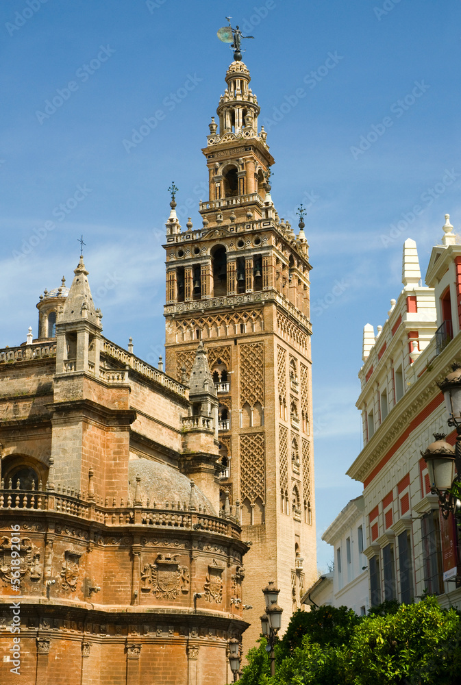 The Giralda tower in Seville, Spain with the Cathedral in foreground