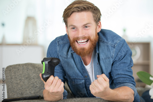 excited young handsome man playing video game
