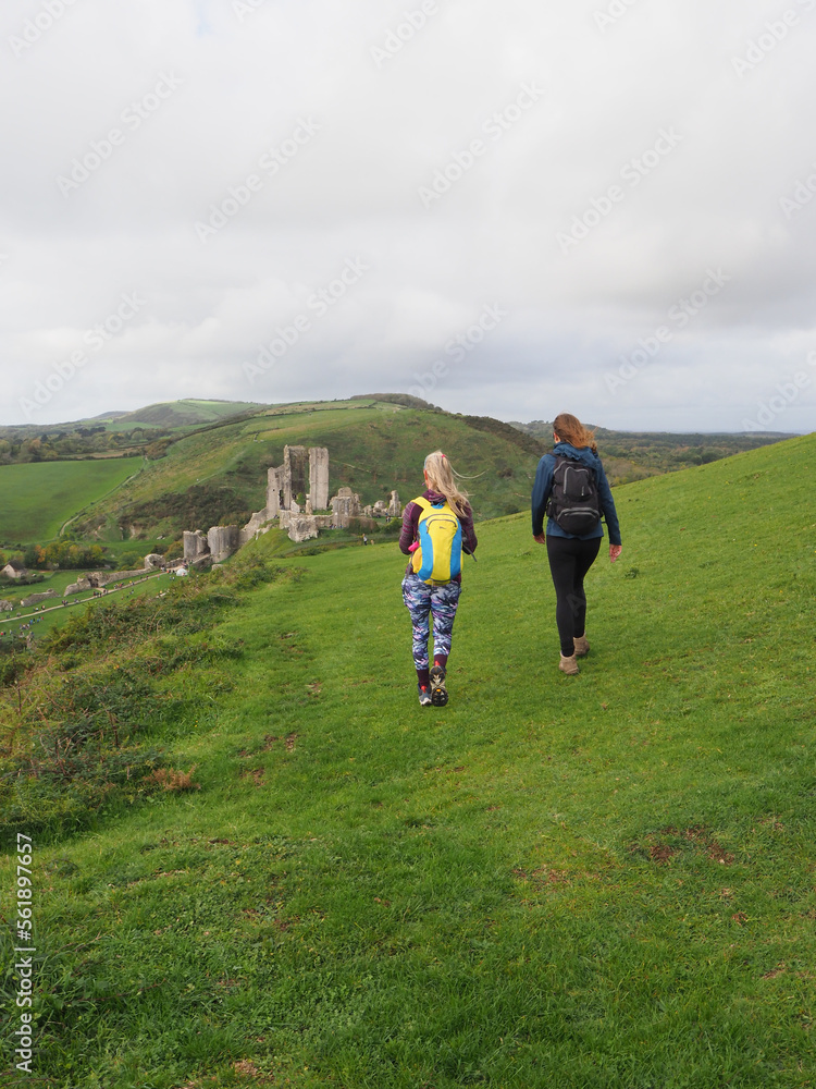 two young women walking towards Corfe Castle in Dorset