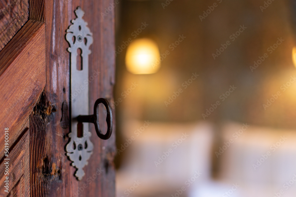 Old key in keyhole on rustic wooden door. Conceptual phptpgraphy for symbol. Idea for history, business, security, religion, secret. Old key in keyhole on rustic wooden door. Conceptual phptpgraphy for symbol. Idea for history, business, security, religion, secret.