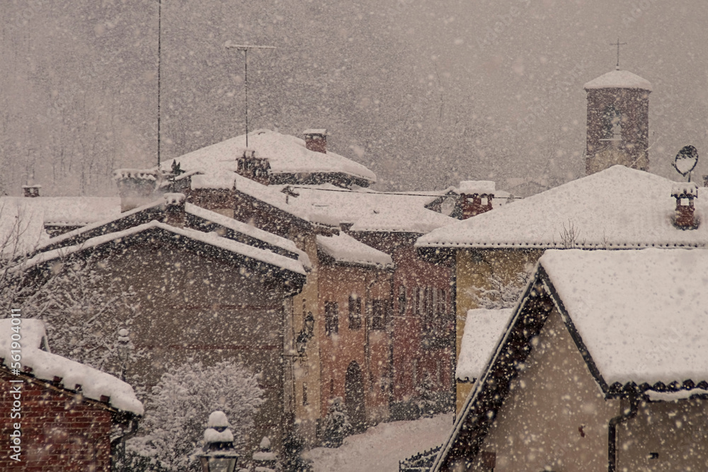 Heavy snowfall on a medieval rustic country town, mediterranean christmas atmosphere - Winter scene - Piedmont, Italy