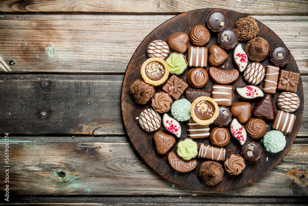 Chocolate sweets on a wooden Board. Chocolate sweets on a wooden Board.