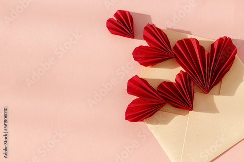 Happy Valentine s day  Stylish envelope with red hearts flat lay on pink paper background. Modern valentine card  space for text. Love banner. Creative letter composition