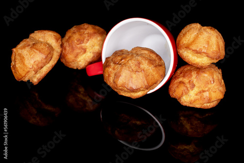 Several shuquettes with a cup , on a black background.