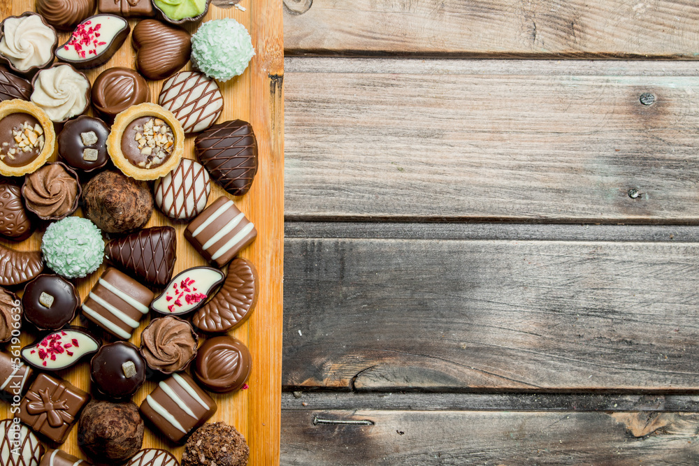 Chocolate sweets on a wooden Board. Chocolate sweets on a wooden Board.
