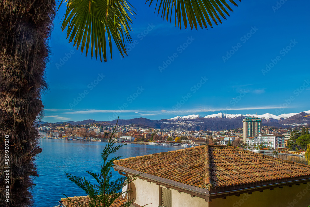Day winter view on Lugano and snow-capped mountains behind