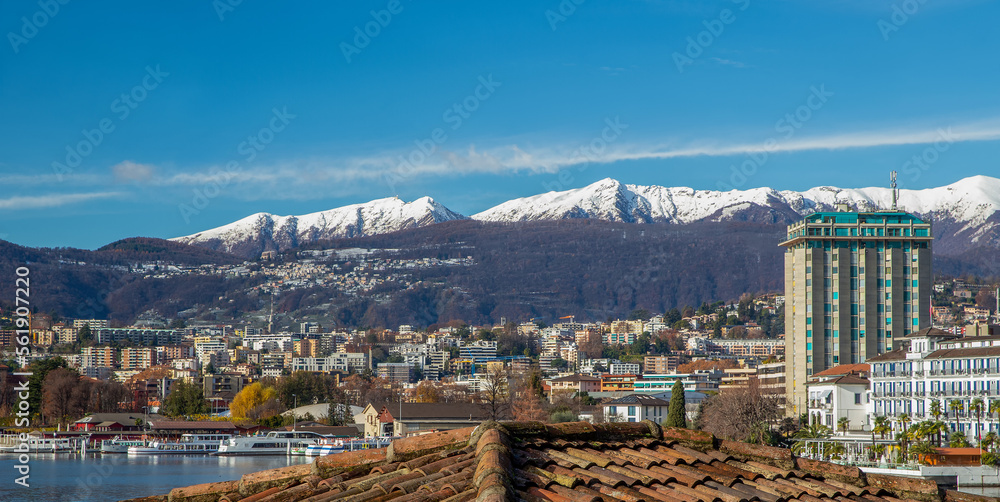 Day winter view on Lugano and snow-capped mountains behind