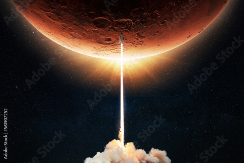 Fototapeta Naklejka Na Ścianę i Meble -  New space shuttle rocket with a blast takes off into space against the background of the red planet Mars and explores space at sunset. Concept of technology and travel to planet. Spaceship lift off