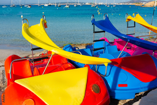 Colorful pedal boats on the sand photo