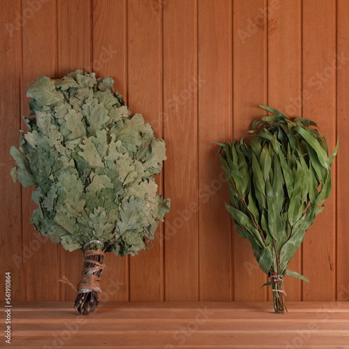 Two dry brooms on a shelf in the sauna. Birch and eucalyptus brooms for the steam room. Square Photo. Wellnes and Aromatherapy