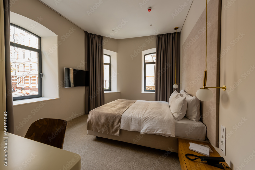 Fototapeta premium comfortable bed with pillows in modern hotel bedroom.