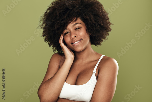 Smiling black woman with curly hair looking at camera