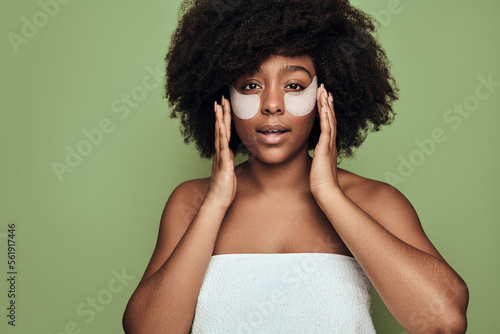 Print op canvas African American woman applying eye patches after shower