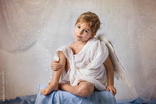 Fototapete Little cupid toddle boy, holding bow and arrow, beautiful blond cherub
