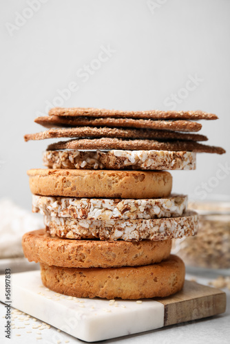 Stack of rye crispbreads, rice cakes and rusks on table, closeup