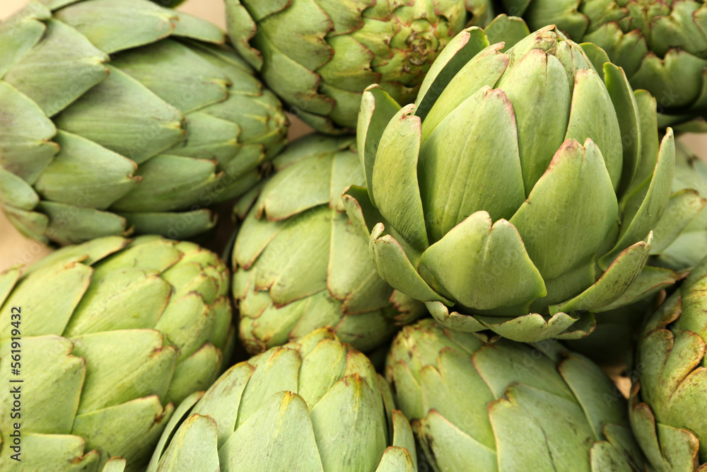 Many fresh raw artichokes as background, closeup Many fresh raw artichokes as background, closeup
