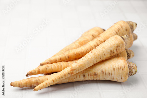 Raw parsley roots on white table, closeup