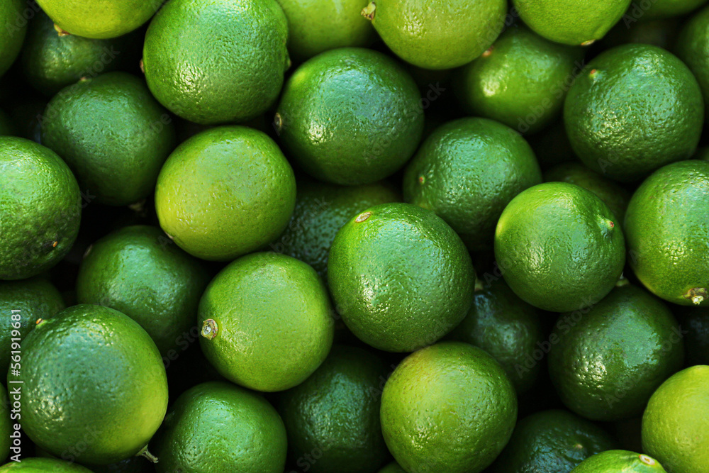 Fresh ripe green limes as background, top view Fresh ripe green limes as background, top view