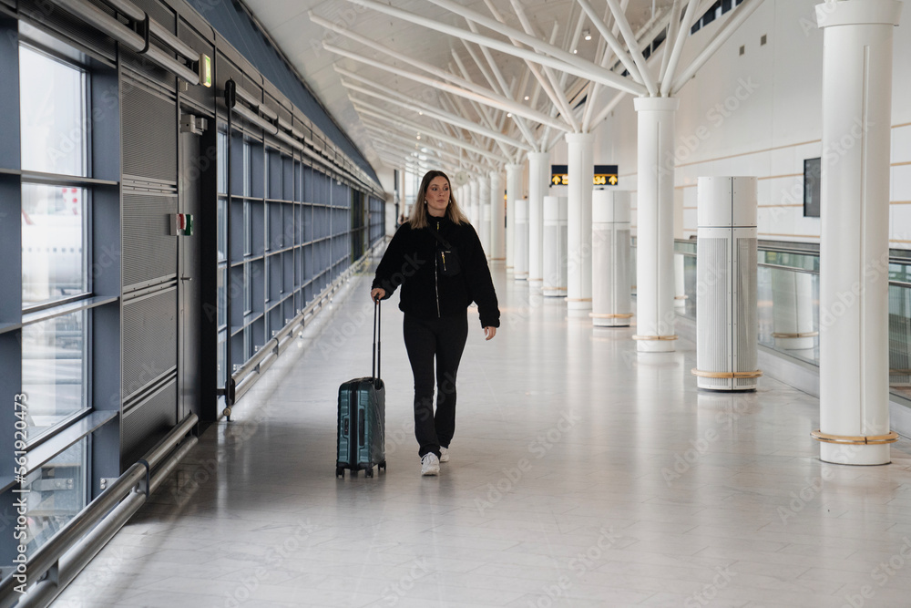Young woman walking in the airport before traveling Young woman walking in the airport before traveling
