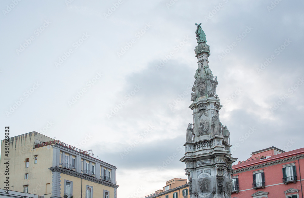 Closeup of obelisk Guglia of the Immaculate Virgin in the center of Piazza Gesù Nuovo located in Naples, Italy Closeup of obelisk Guglia of the Immaculate Virgin in the center of Piazza Gesù Nuovo located in Naples, Italy