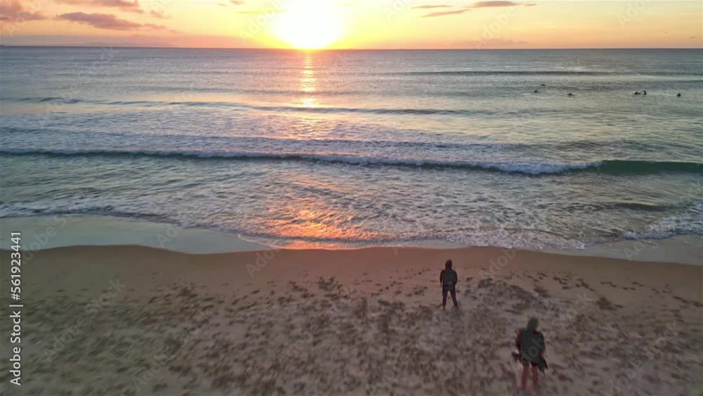 Sunset Surfing, forward/upward and backward/downward surfer catching wave in the middle of a shot Sunset Surfing, forward/upward and backward/downward surfer catching wave in the middle of a shot