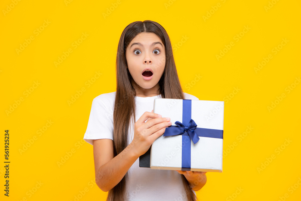 Amazed surprised emotions of young teenager girl. Teenager kid with present box. Teen girl giving birthday gift. Present, greeting and gifting concept. Amazed surprised emotions of young teenager girl. Teenager kid with present box. Teen girl giving birthday gift. Present, greeting and gifting concept.