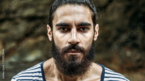 Young brutal bearded man cloes up photo