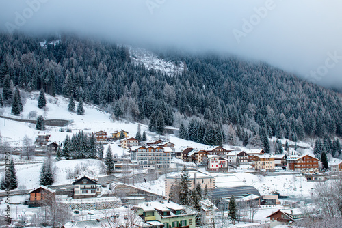 Cottages and chalets of Moena in Italian Dolomites in January under the snow.