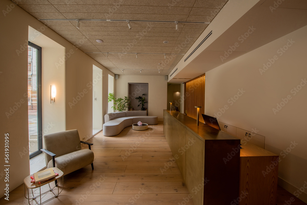 interior of luxury hotel lobby with reception desk near modern sofa and ...
