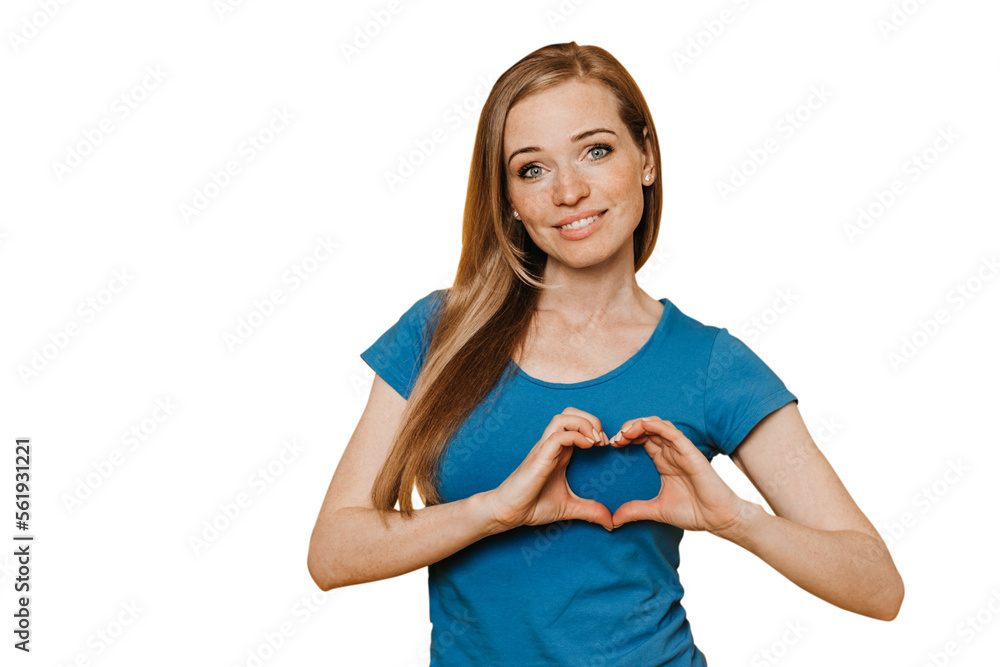 Smiling young redhead woman girl in blue t-shirt posing isolated on transparent background. People lifestyle concept. Mock up copy space. Showing shape heart with hands, heart-shape sign
