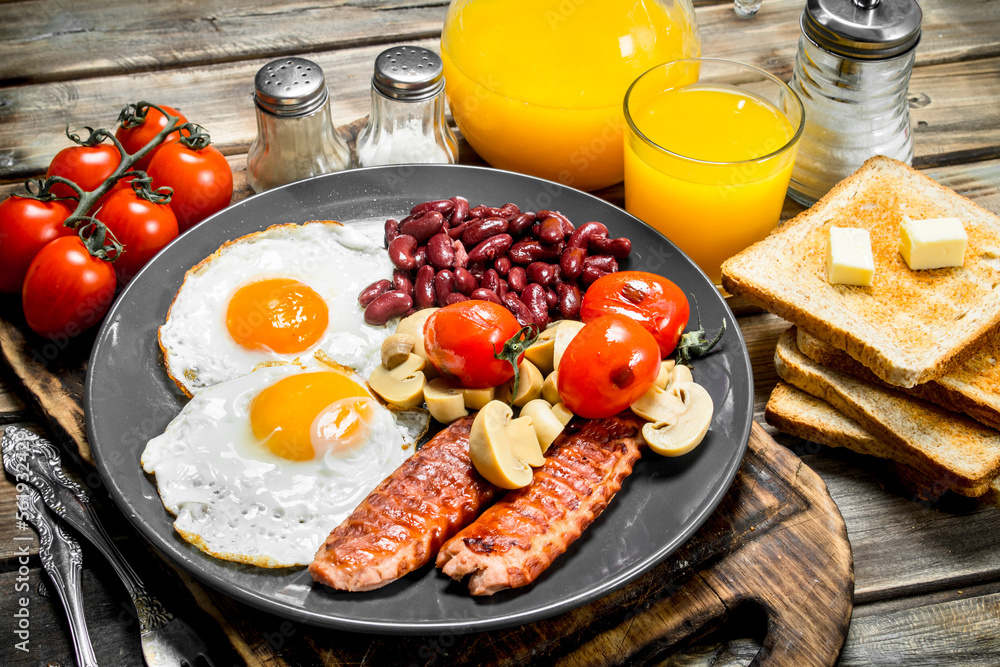 Traditional English breakfast. Fried eggs with beans, sausages and fried bread. Traditional English breakfast. Fried eggs with beans, sausages and fried bread.