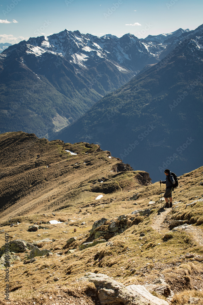 man standing on mountain path in the carinthian alps enjoying. the view south.