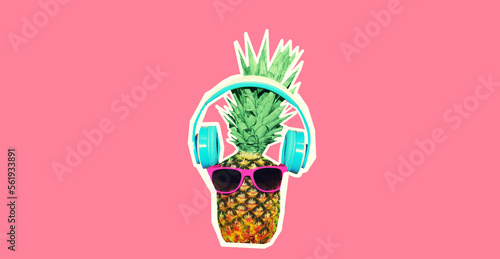 Close up of funny pineapple listening to music in headphones on pink background, magazine style