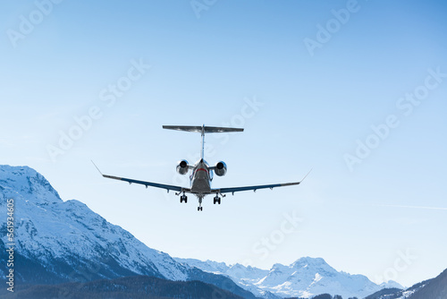 Luxurious business jet landing in the Swiss alps. Airplanes like this are the way to travel to the witner resort of St. Moritz for successful business people