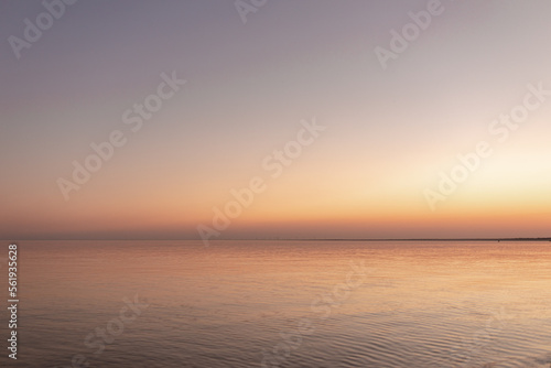 sunset sun by the ocean, clear water and sandy azure beach © Ванжа Юрий
