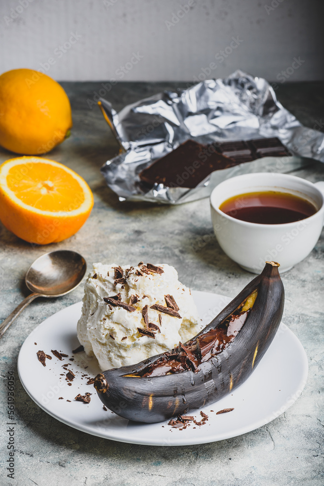 Grilled banana with dark chocolate and vanilla ice cream. Grilled banana with dark chocolate and vanilla ice cream.