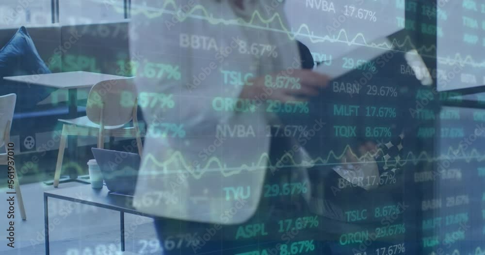 Animation of trading board moving over diverse male coworkers discussing plan over laptop in office Animation of trading board moving over diverse male coworkers discussing plan over laptop in office