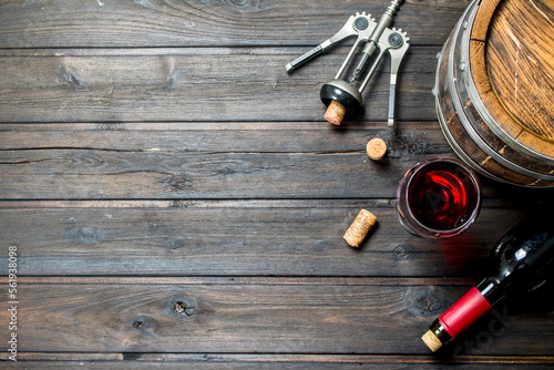 Wine background. A barrel of red wine with a corkscrew.