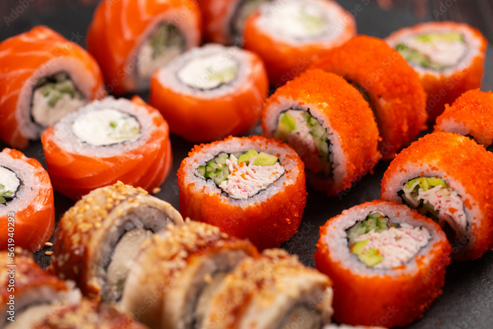 Rolls set with fish shrimp and caviar sushi with chopsticks - asian food and japanese cuisine concept Rolls set with fish shrimp and caviar sushi with chopsticks - asian food and japanese cuisine concept