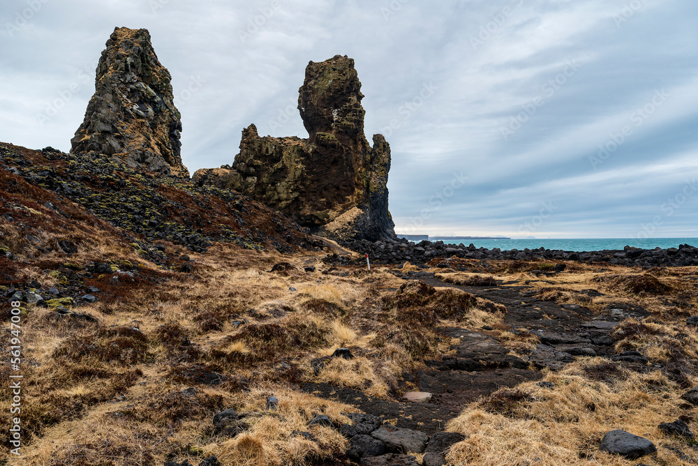 Footpath leading towards the impressive Lóndrangar basalt rock pinnacles on the coast near Malarrif, Snæfellsjökull National Park, Snæfellsnes, Iceland