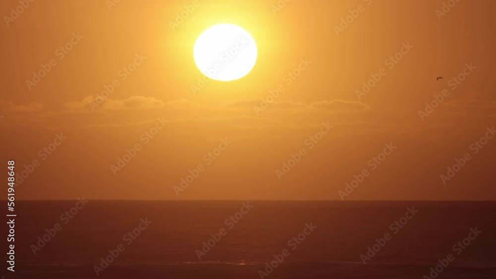 Bright sun sets over the sea - orange sunset Bright sun sets over the sea - orange sunset