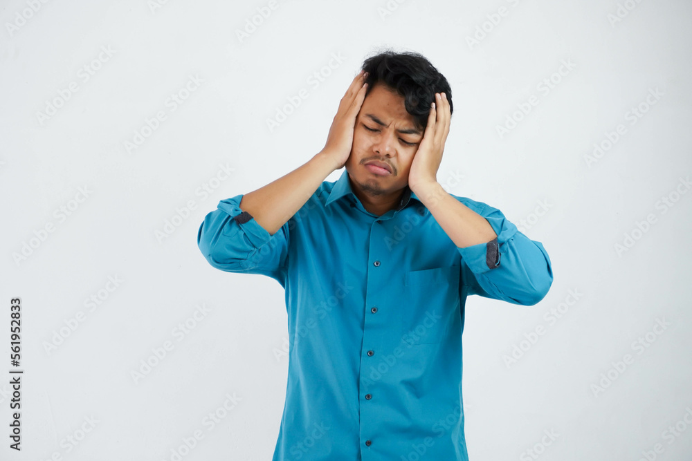dizziness or stress portrait young asian man holding head wearing blue shirt isolated on white background dizziness or stress portrait young asian man holding head wearing blue shirt isolated on white background