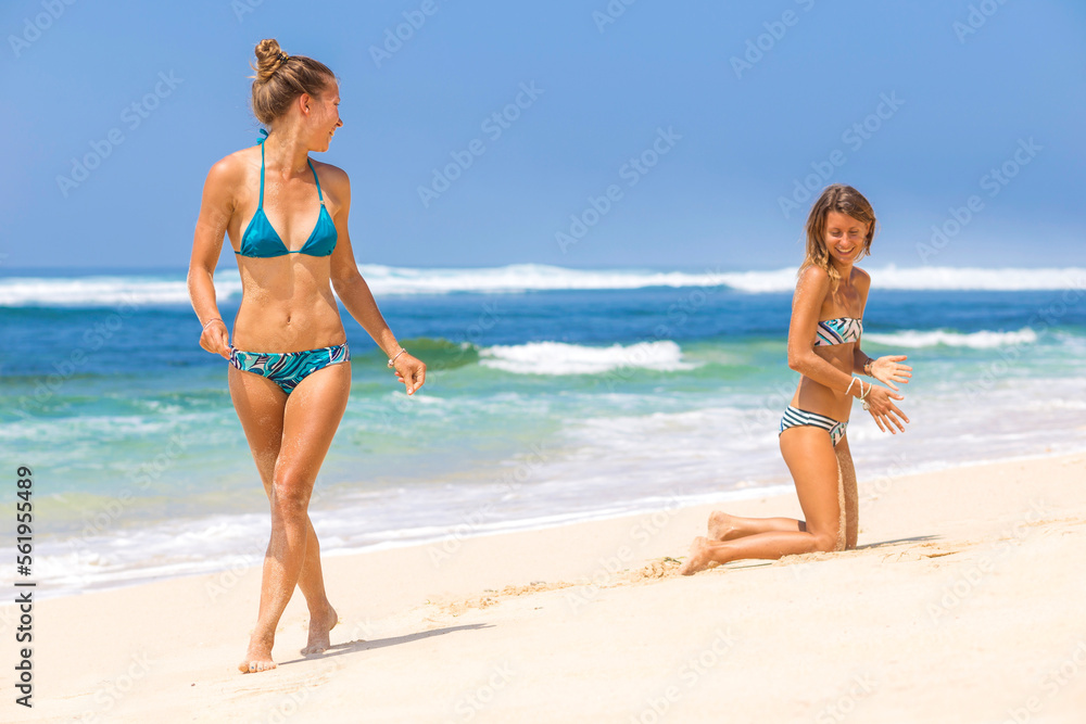 Two beautiful girls walking in the beach and having fun. Two beautiful girls walking in the beach and having fun.